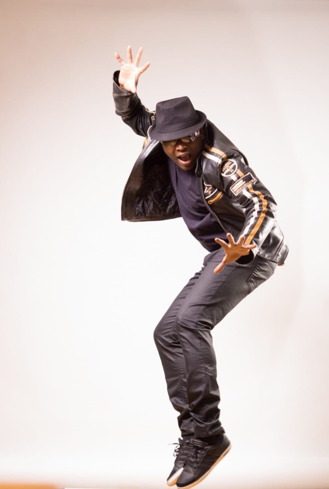 Mister Kibs mid-jump in a leather jacket
