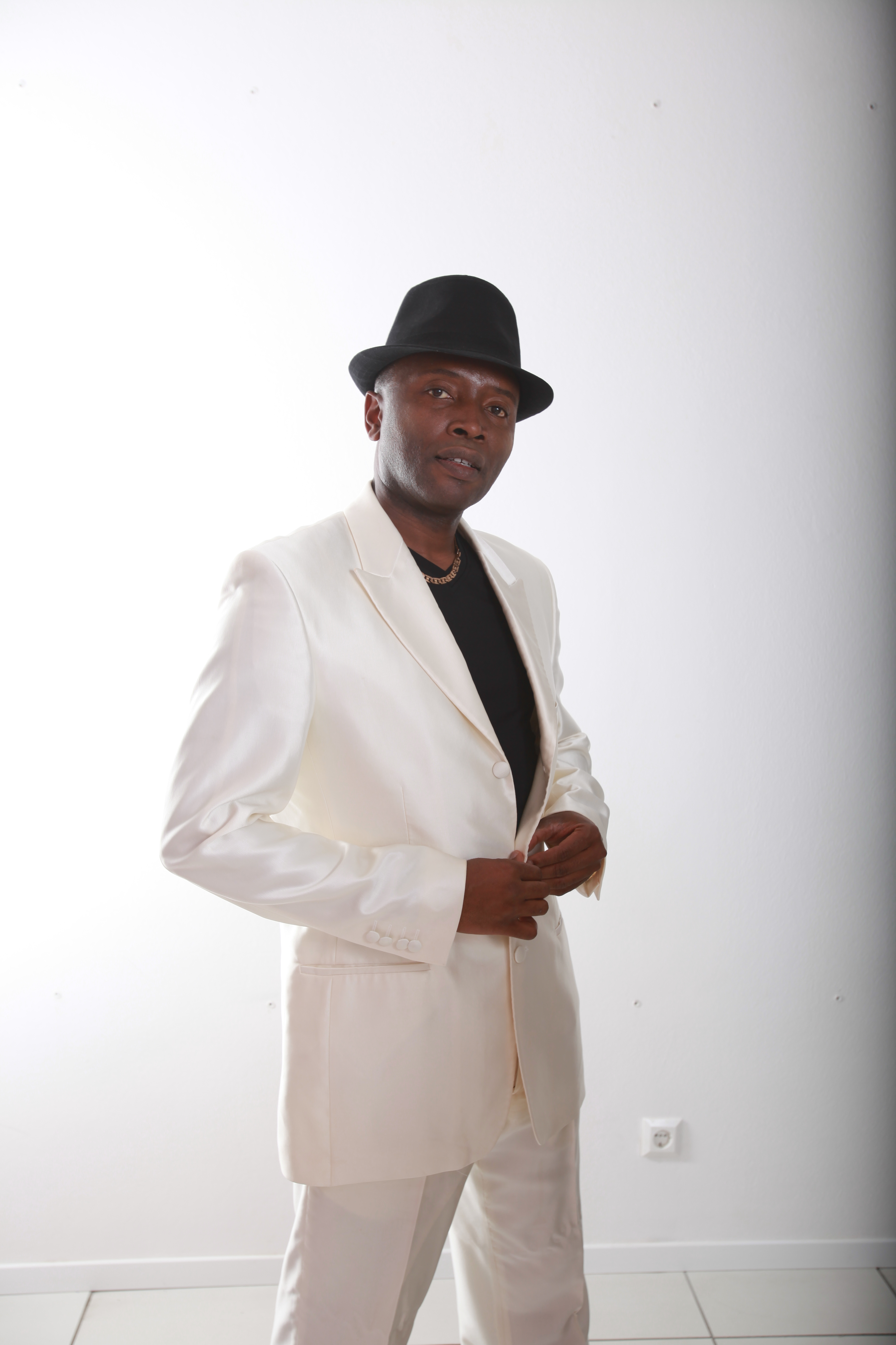 Mister Kibs in a cream suit and hat